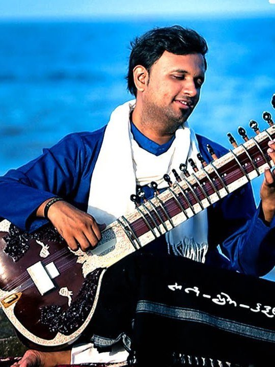 Bhagirath Bhatt playing beside the sea