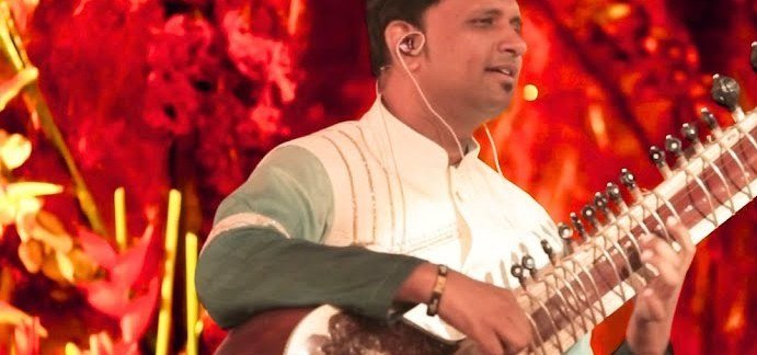 Bhagirath Bhatt in performance against a warm stage